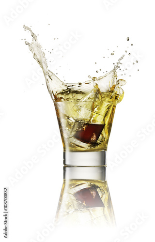 Splash in alcoholic drink on white background