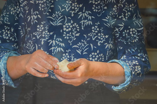 Closeup of hands making Chinese Steamed Bun