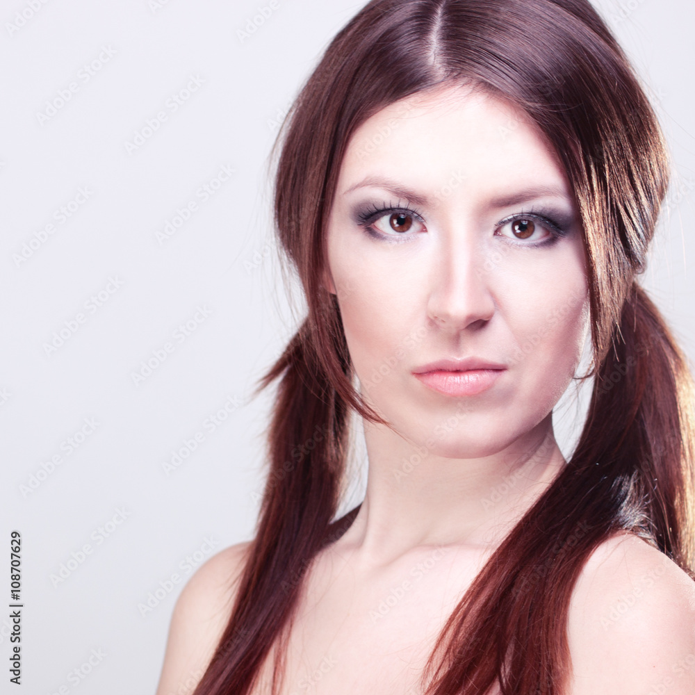 Beautiful girl with brown hair, glamorous make-up, fashion style portrait of a woman looking attentively Beautiful girl with brown hair, glamorous make-up, fashion style portrait of a woman looking attentively