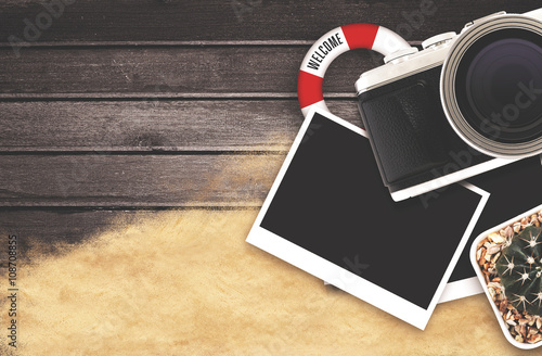 vintage  design, camera and blank photo frames on black wooden table. top view