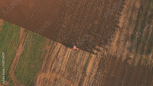 aerial video of tractor plowing a field