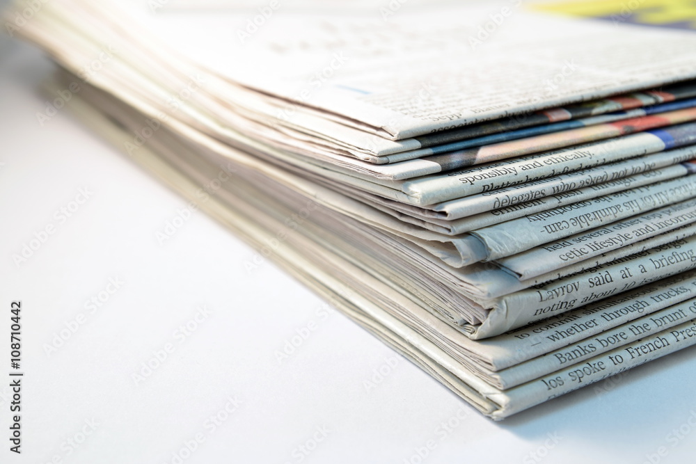 Stack of newspapers on white background Stack of newspapers on white background