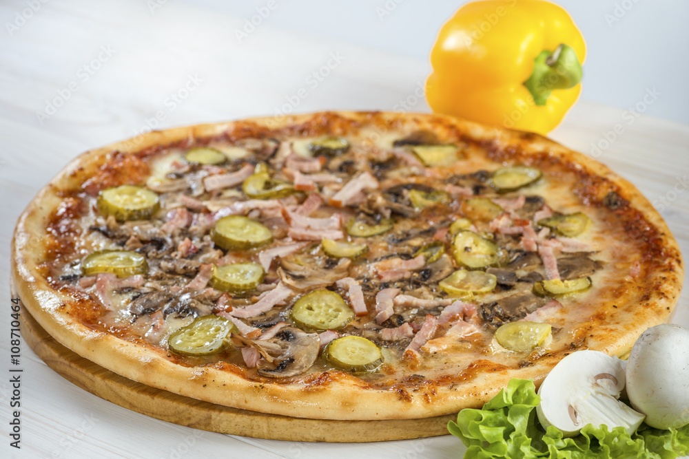 tasty pizza on a wooden board with pepper and mushrooms