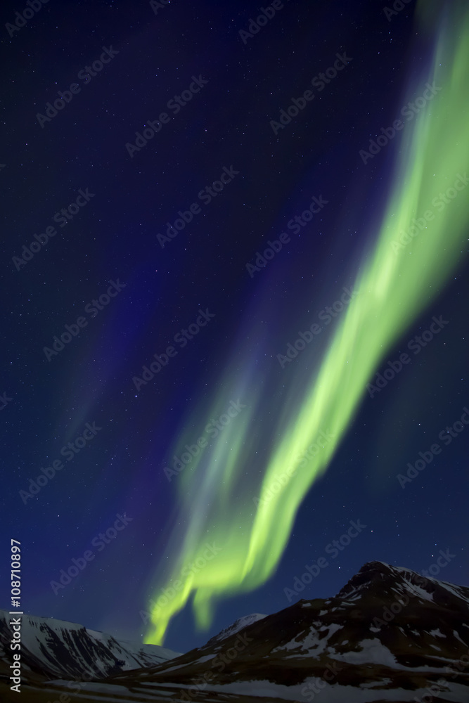 Northern Lights above mountains edge