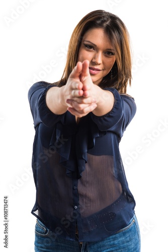Young girl making gun gesture