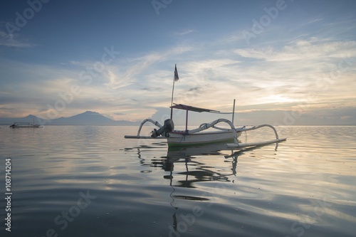 Sunrise Scene in Bali, Indonesia. The rowboat or 