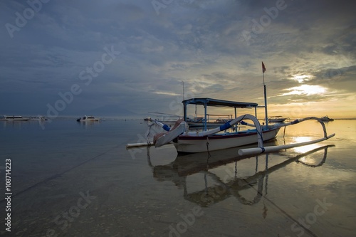 Sunrise Scene in Bali, Indonesia. The rowboat or 