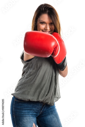 Young girl with boxing gloves © luismolinero
