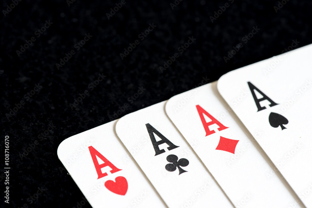 Playing card on black table, four a kind aces