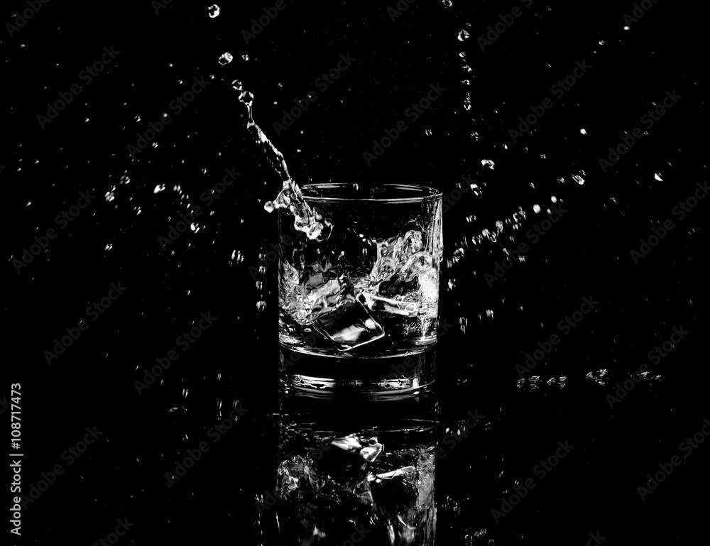 Isolated shot of whiskey with splash on black background Isolated shot of whiskey with splash on black background