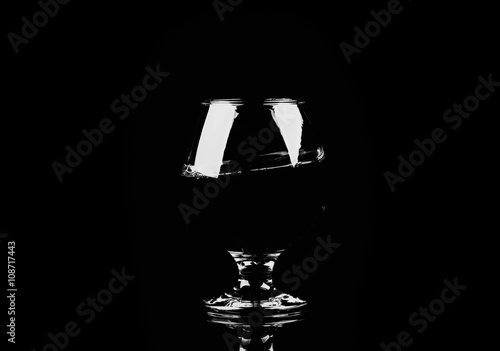 glass with cognac on a black background © The Len