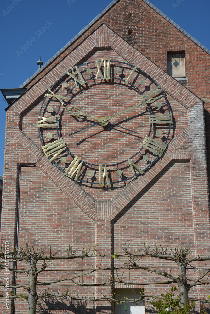 Lier, Belgium. Clockwork on the side facade of the city library, former clock face of the Saint Gummarus church.