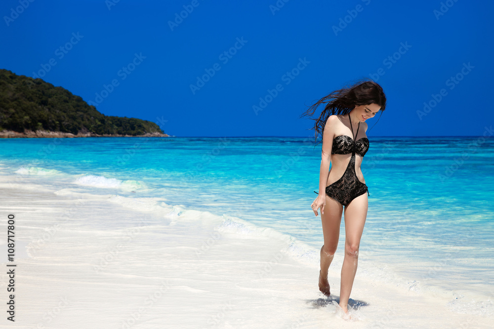 Brunette Woman On Tropical Beach. Summer vacation. Happy girl wa