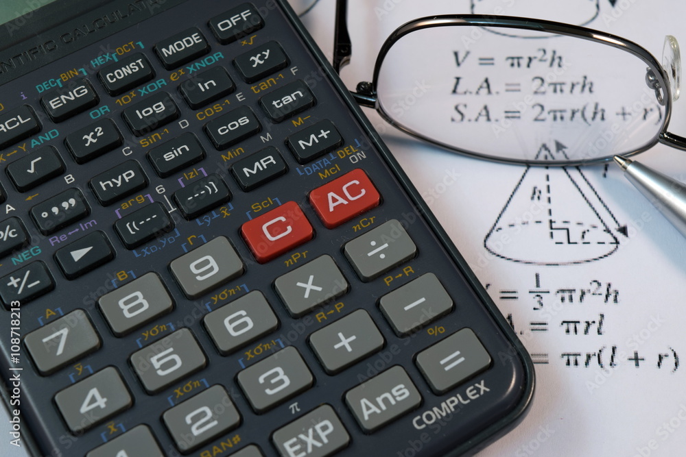 Eye Glasses, pen and pencil over the Formula with calculator Eye Glasses, pen and pencil over the Formula with calculator