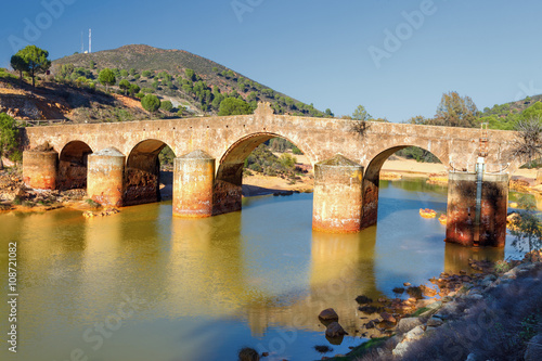Old bridge in San Rafael on the Odiel river, Spain photo