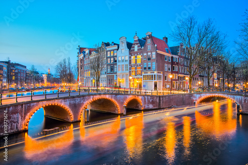 Amsterdam canals with bridge and typical dutch houses in Netherl