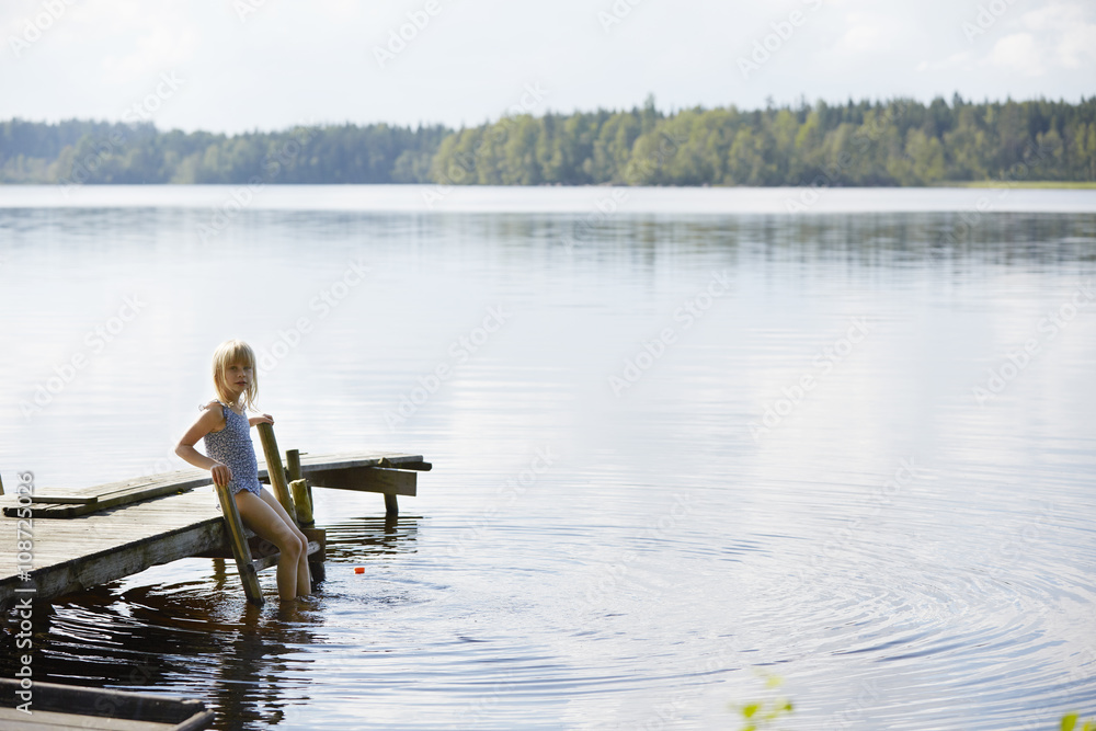 Portrait of girl on wooden ladder at dock Portrait of girl on wooden ladder at dock
