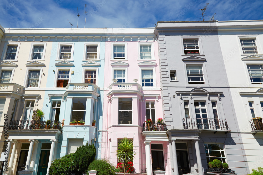 Naklejka premium Colorful English houses facades, blue sky in a sunny day