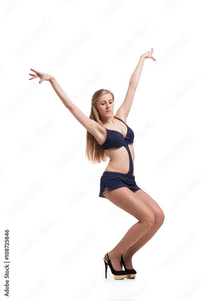 Young beautiful dancer posing on studio background