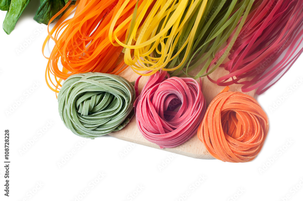 Different kinds of colorful raw italian pasta and its natural ve