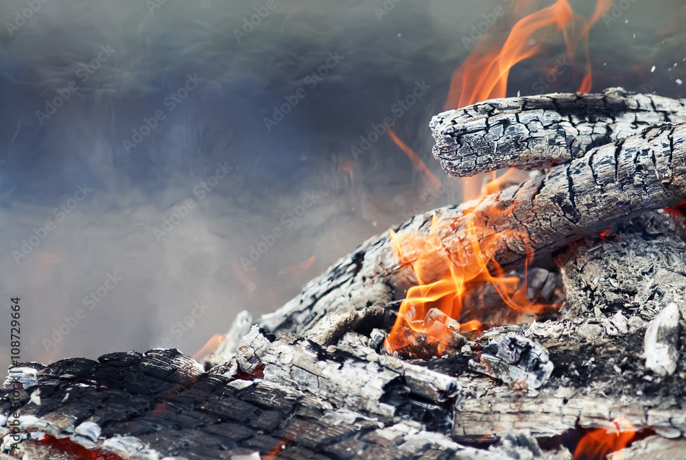 burning up white hot coals and the bright red flames of a fire burning up white hot coals and the bright red flames of a fire