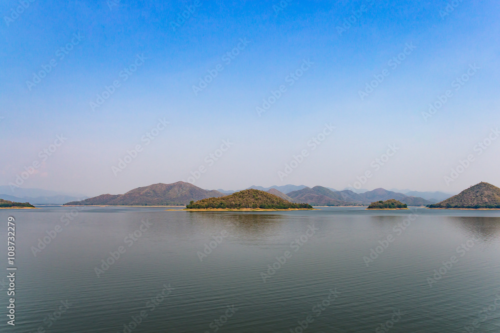 Lake and mountains landscape on rainless day.