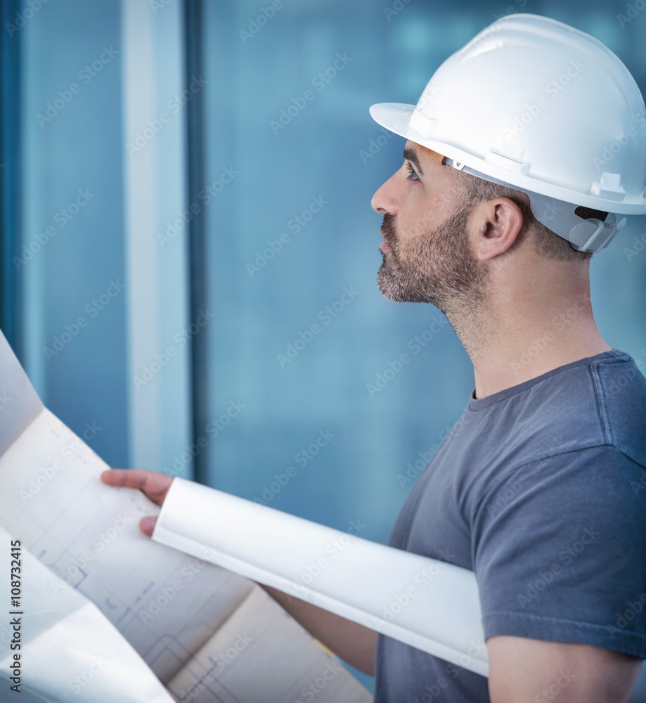 Architect builder studying layout plan of the room Architect builder studying layout plan of the room