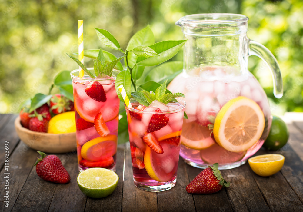 Pink lemonade with lemon, lime and strawberries Pink lemonade with lemon, lime and strawberries