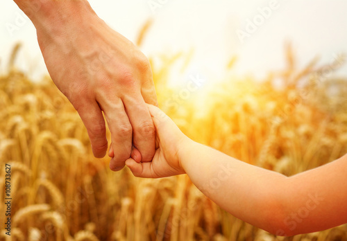 hands of child and father