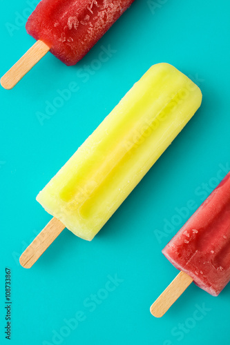 Strawberry popsicles. Blue background
