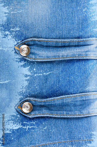 Old denim background with metal buttons