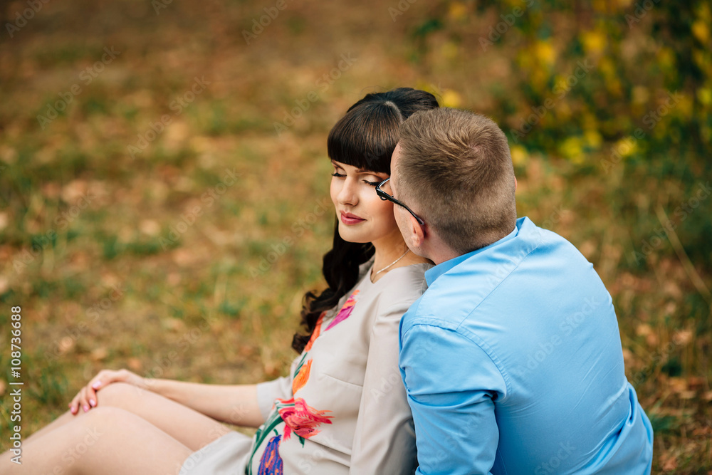 Happy and young pregnant couple lovely hugging outdoors Happy and young pregnant couple lovely hugging outdoors