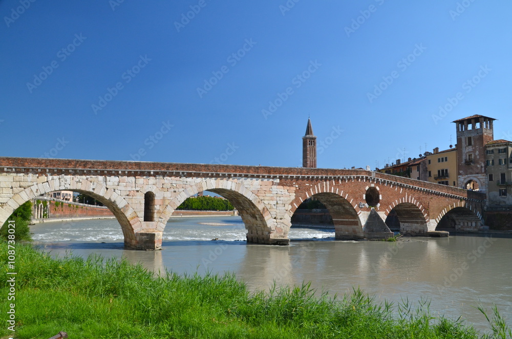 Ponte Pietra on river Adige, ancient roman bridge in the old town of Verona, Italy
