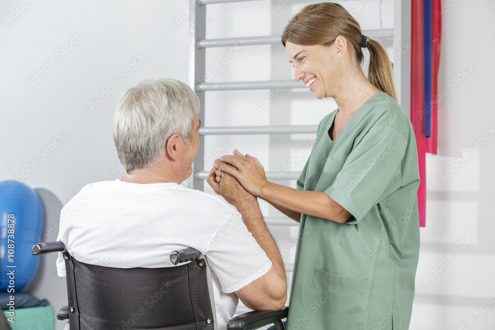 Fototapeta premium Physical therapist helps an elder patient