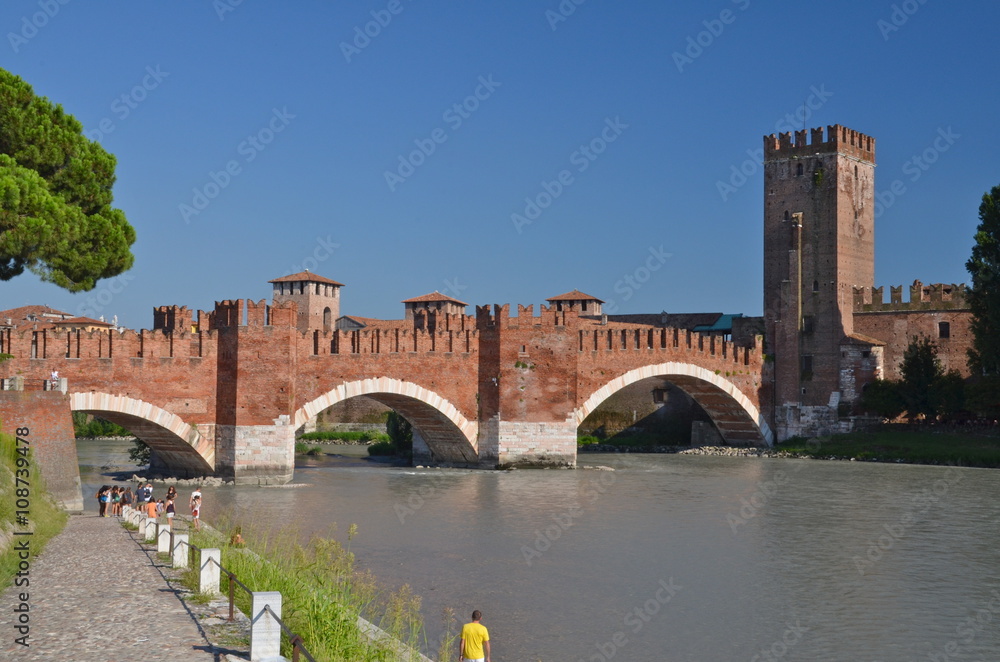 Medieval stone bridge Ponte Scaligero across the river Adige and tower of Castelvecchio, Verona, Northern Italy.
