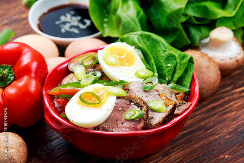 Duck noodles with egg, vegetables and duck meat in bowl