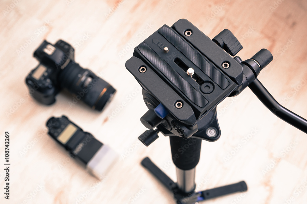 equipment for photo and video shooting - the camera, the flash and a tripod