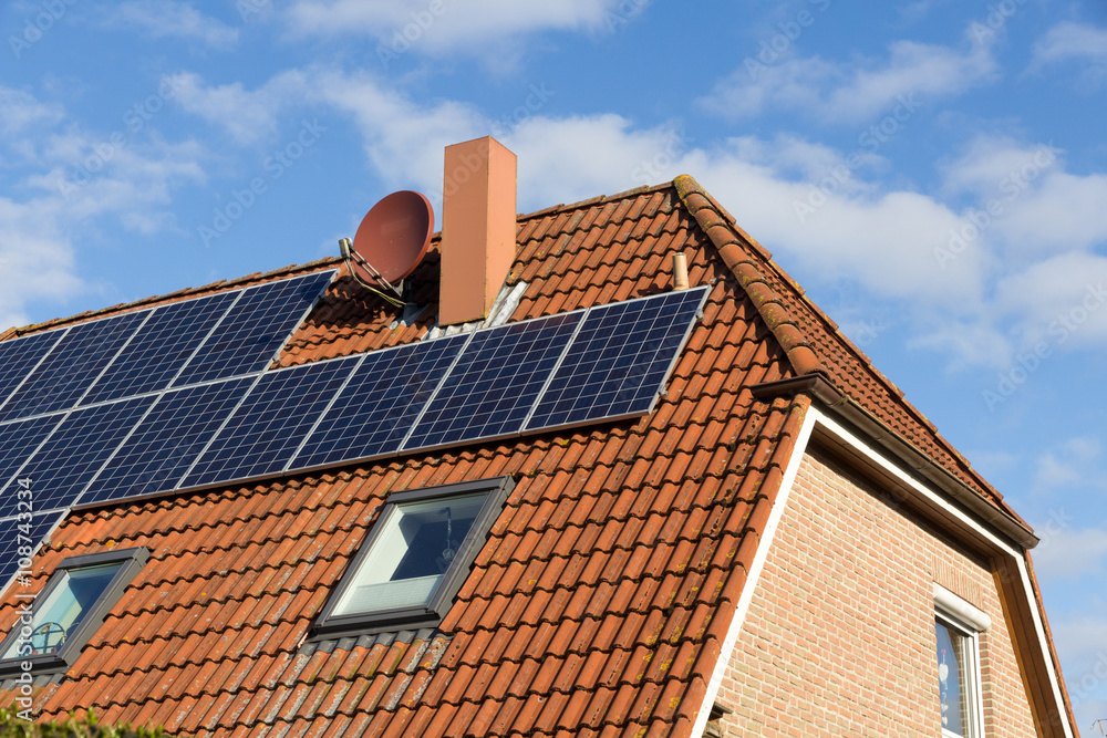 Fototapeta premium house with solar panels on the roof