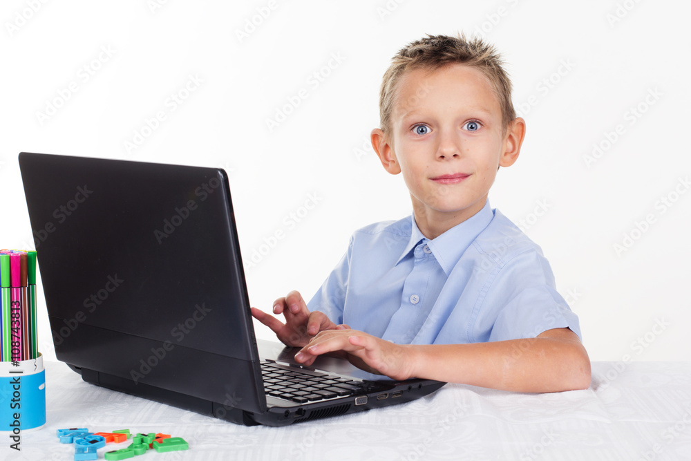 Happy schoolboy is doing homework Happy schoolboy is doing homework