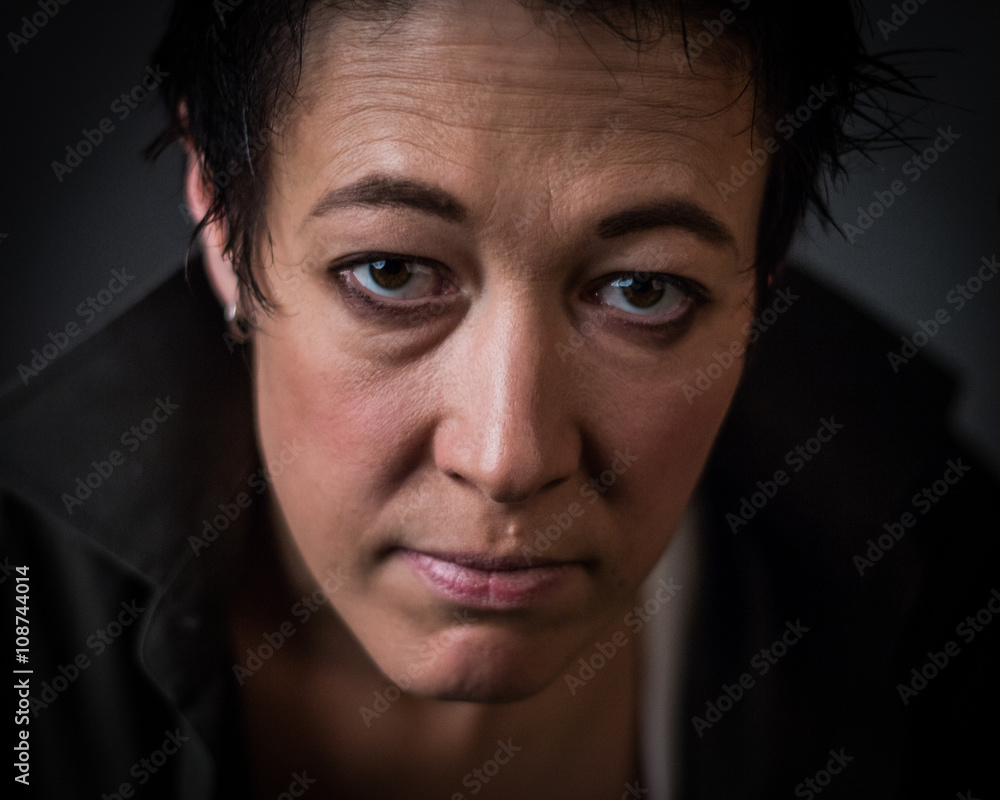 Obraz premium Androgynous character on a gray background. Man or woman. Military style. Very sharp. 