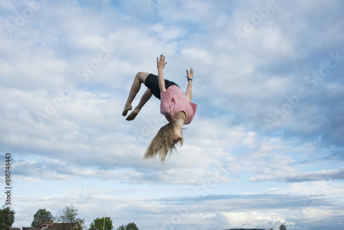 Girl doing somersault mid-air