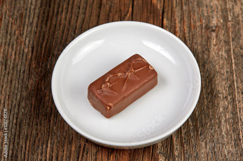Chocolate bar on a brown wooden table