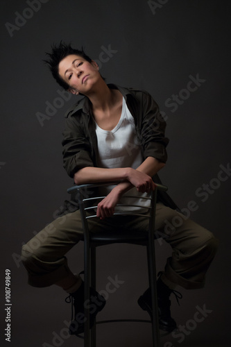 Androgynous character on a gray background. Man or woman. Military style. 
