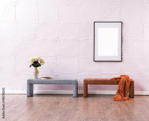 soft pink background empty wall wooden floor orange blanket and bench with gold mirror office concept interior decoration photo