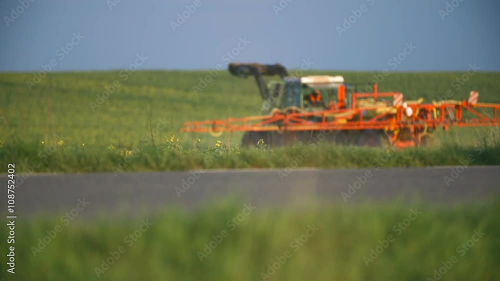 Tractor spray fertilize on field with chemicals in agriculture field. Tractor spray fertilize on field with chemicals in agriculture field.