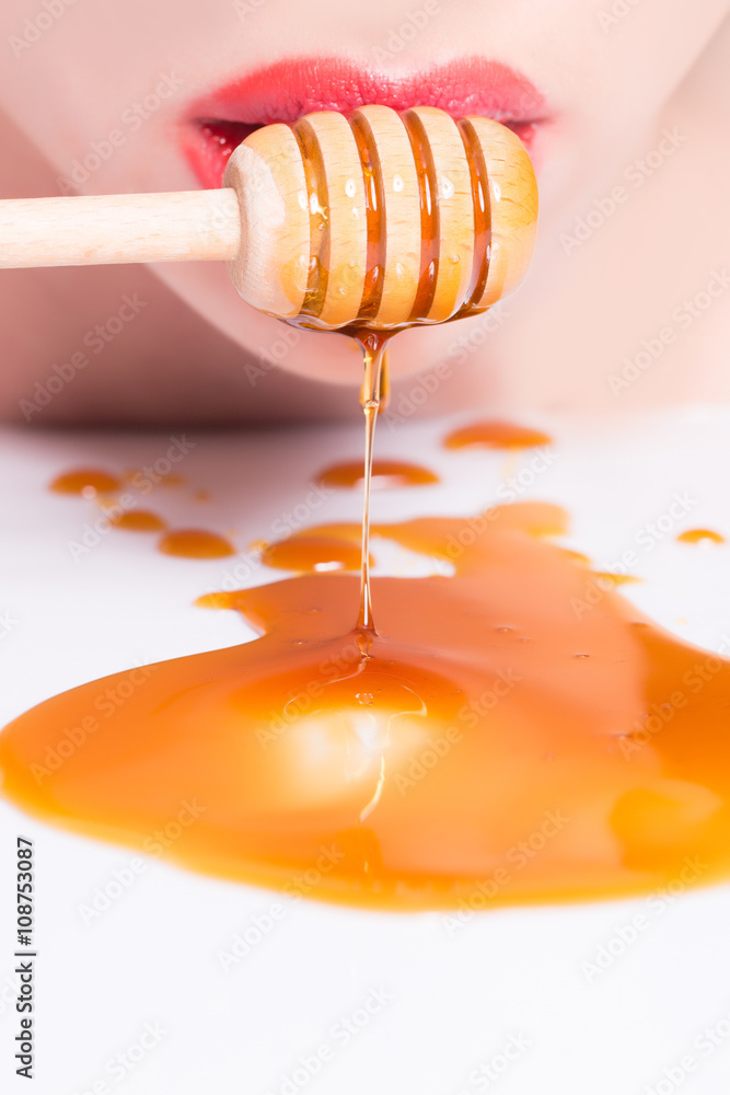 Female lips with honey Female lips with honey