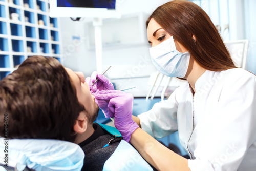 Overview of dental caries prevention.man at the dentist's chair during a dental procedure.