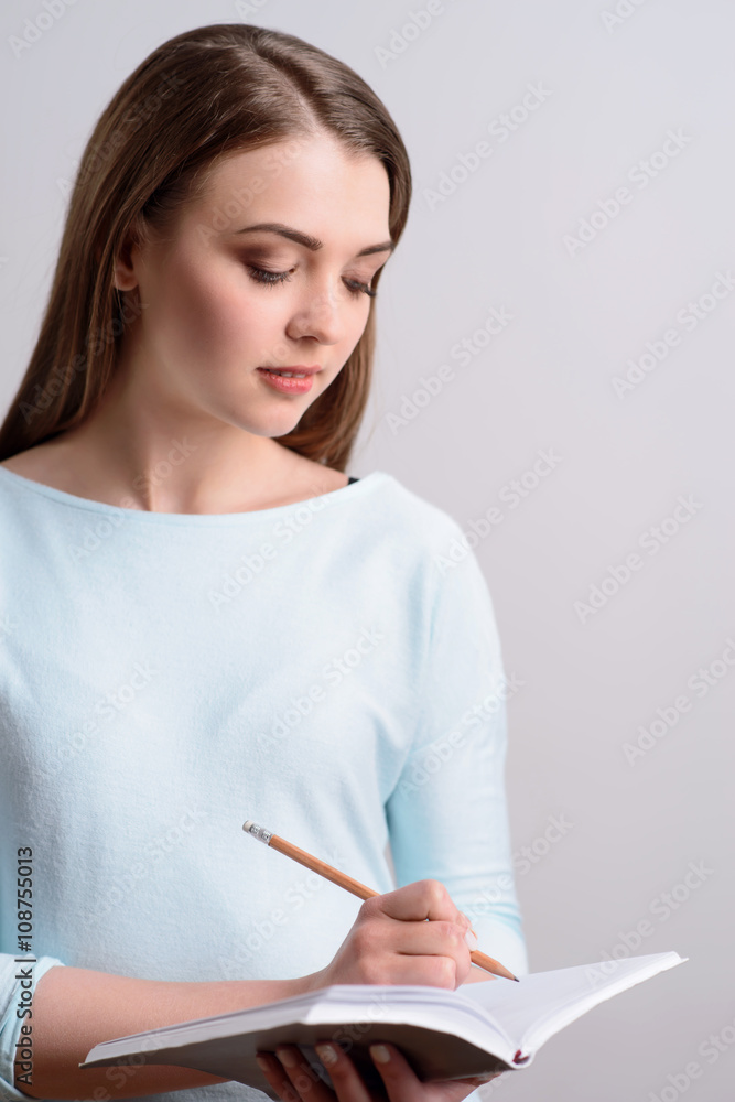 Delighted nice girl making notes Delighted nice girl making notes