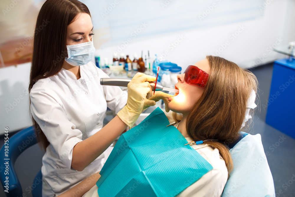 Overview of dental caries prevention.Woman at the dentist's chair during a dental procedure. Beautiful Woman smile close up. Healthy Smile. Beautiful Female Smile
Overview of dental caries prevention.Woman at the dentist's chair during a dental procedure. Beautiful Woman smile close up. Healthy Smile. Beautiful Female Smile