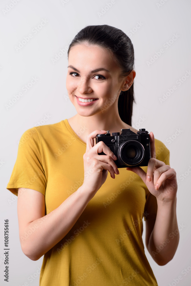Positive girl holding photo camera Positive girl holding photo camera
